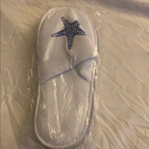White slide on slippers with blue starfish on top